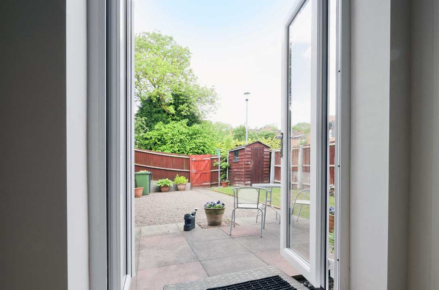 One of our best patio doors was installed in our client's house showing a view of the patio outside