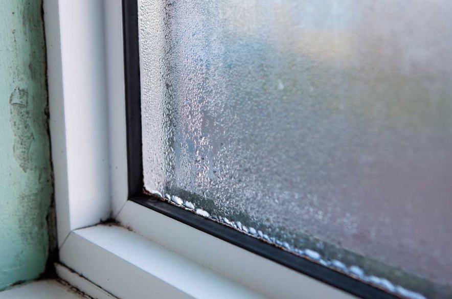house window with damp and condensation on windows damaging the structure