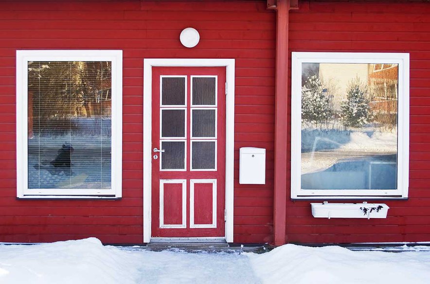 A red weather door with windows giving a fresh look to the home while enhancing its appeal. 
